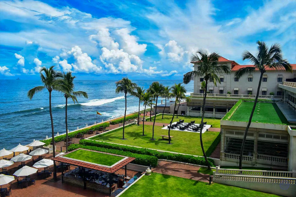 Luxurious Galle Face Hotel in Colombo, Sri Lanka, with a vast green lawn by the sparkling ocean.