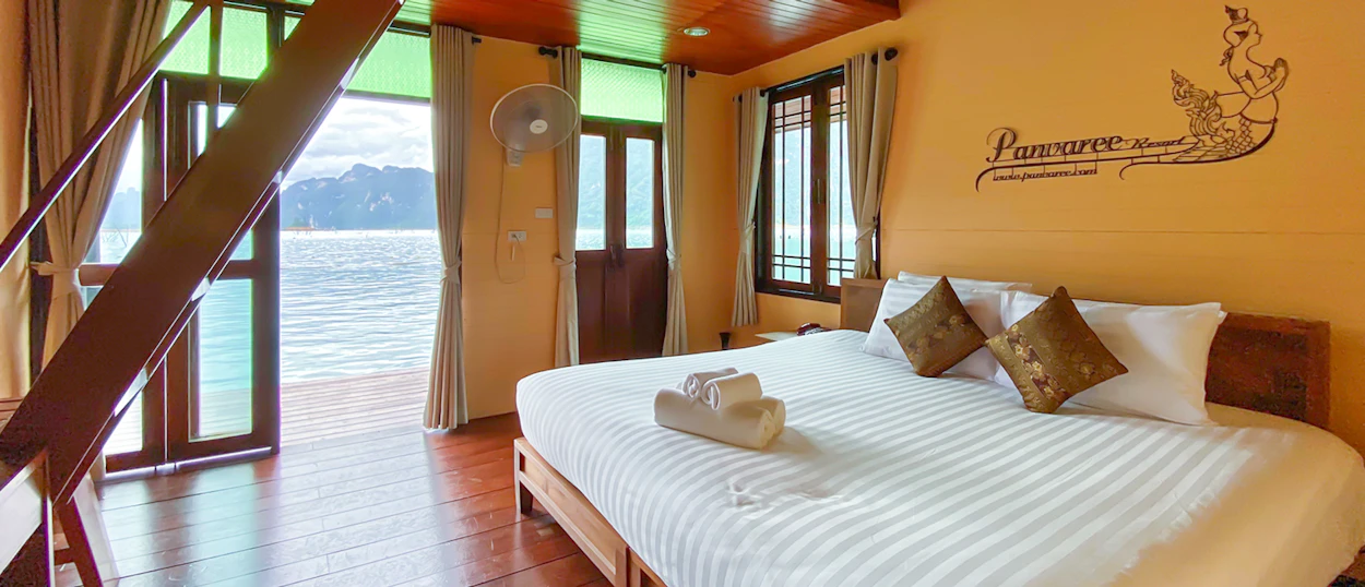 Inviting bedroom in a floating bungalow at Khao Sok, with a comfortable bed and serene lake views.