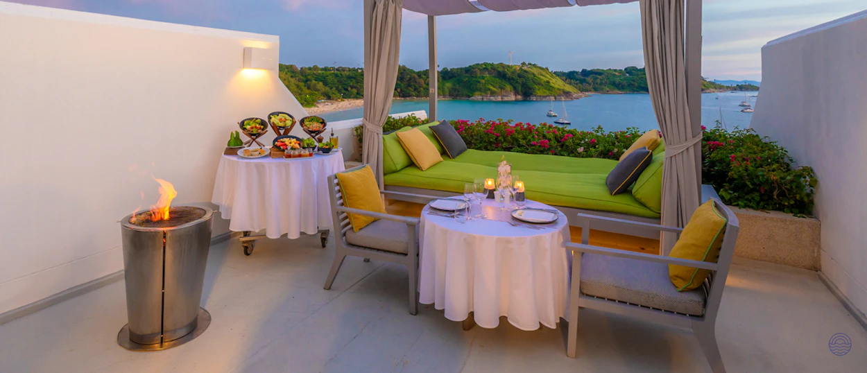 Luxurious private terrace in Phuket with a romantic dinner, fire pit, and stunning ocean view.