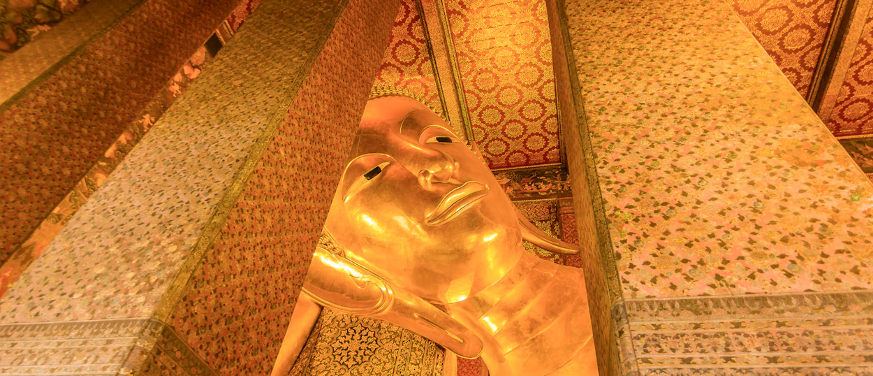 A close-up of the magnificent golden reclining Buddha statue at Wat Pho, Bangkok.